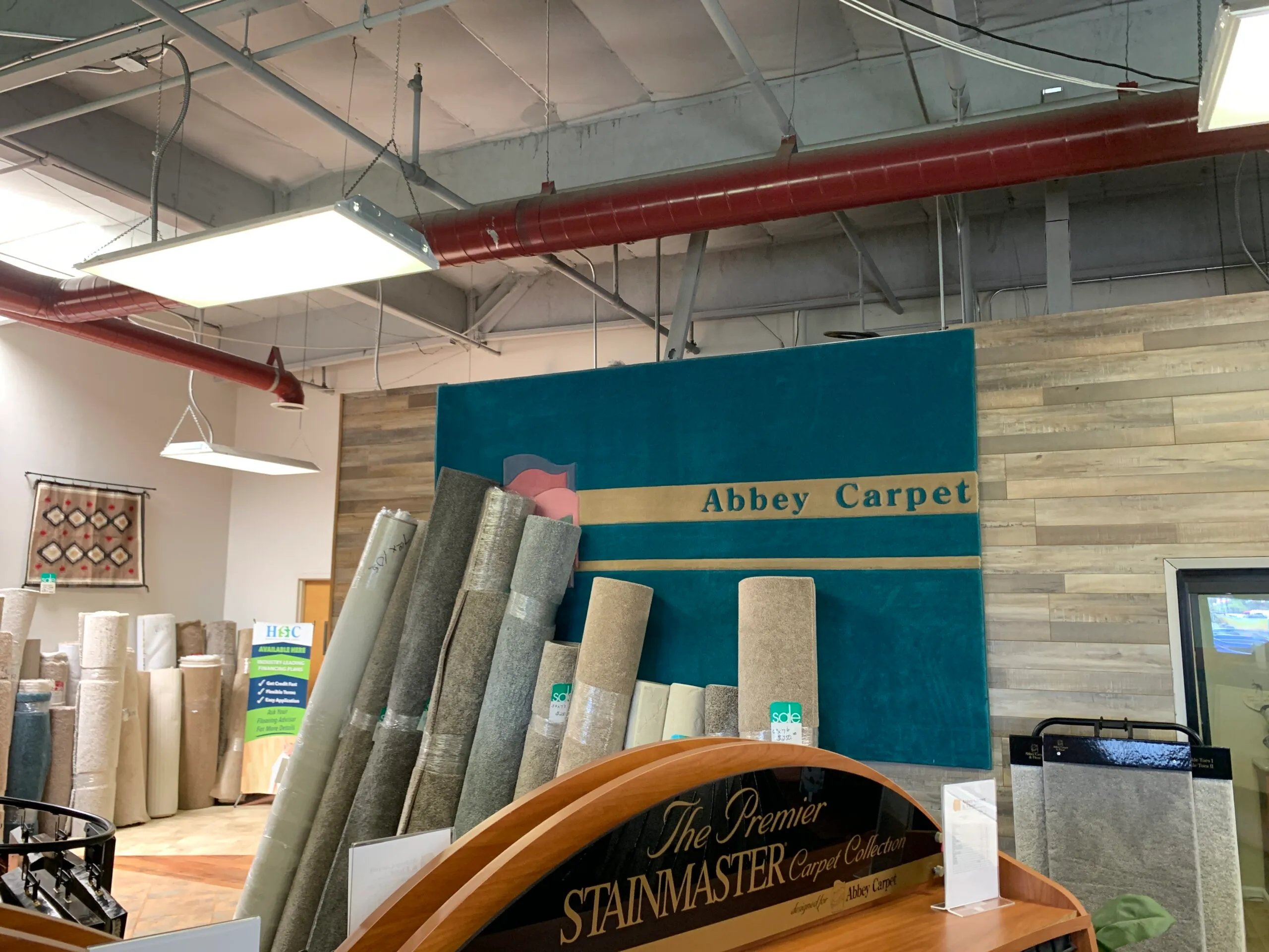 Picture of In the calm of Abbey Carpets by Fashion Floors, neatly stacked carpet rolls hint at a commitment to quality outcomes. Their focus on premium materials reflects why they consistently achieve a Highest in Quality rating. Copyright ©2025 Diamond Certified Resource

 - Abbey Carpets by Fashion Floors