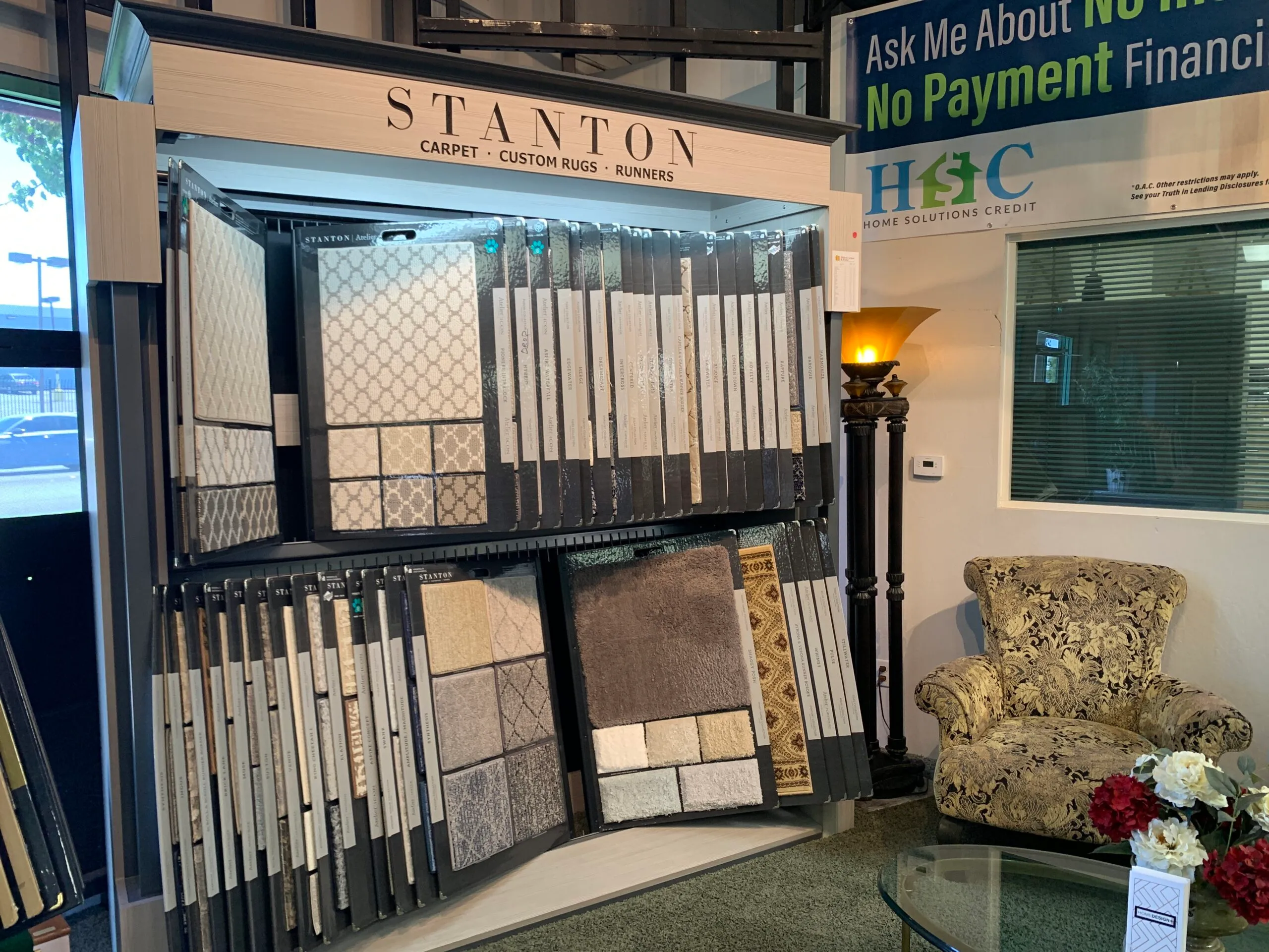 Picture of A showroom corner at Abbey Carpets by Fashion Floors showcases a refined selection of Stanton carpet samples, hinting at the elegance that awaits every visitor. The company is recognized for expertise and quality. Copyright ©2025 Diamond Certified Resource - Abbey Carpets by Fashion Floors