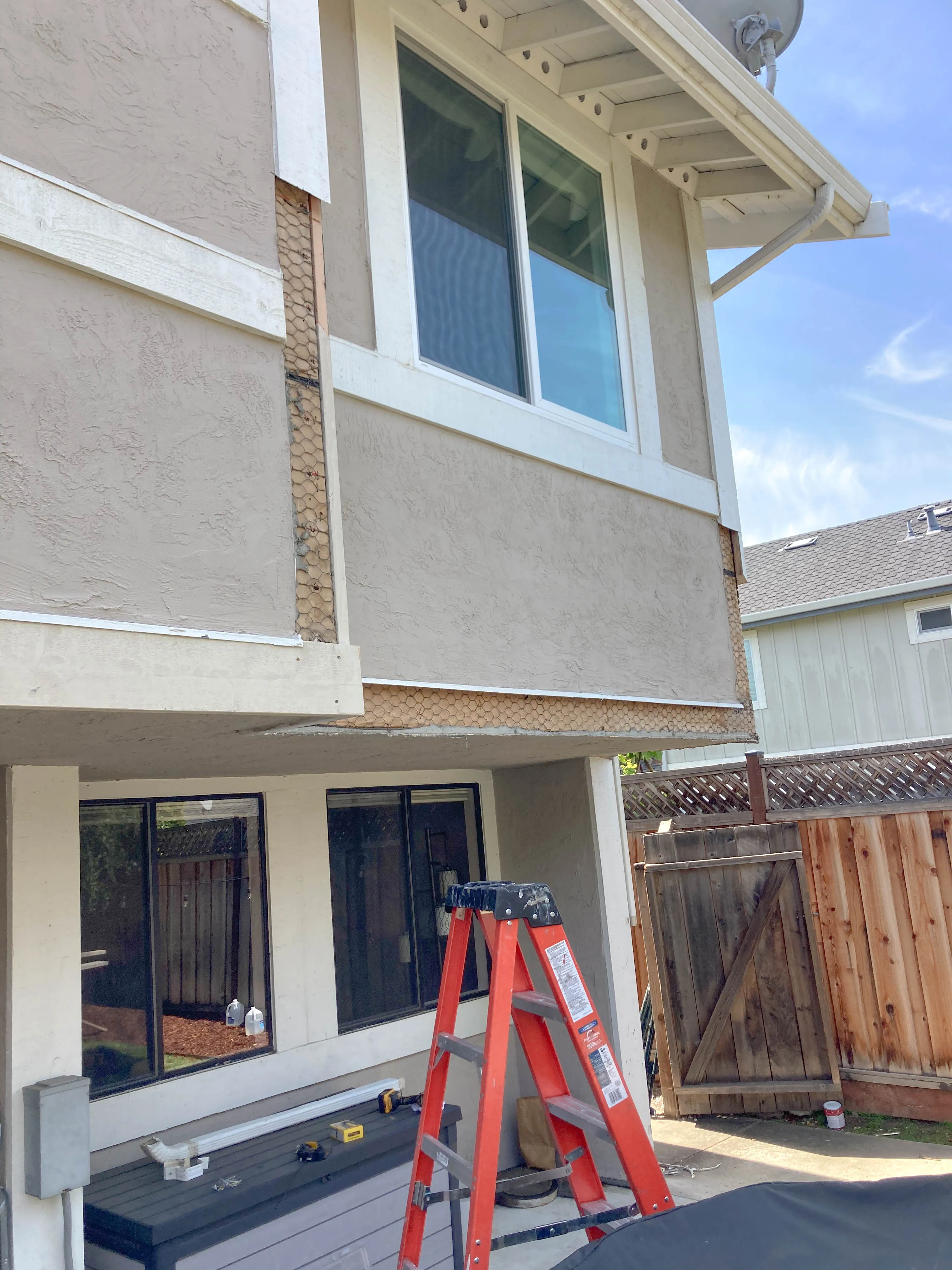 Picture of A red ladder stands ready as a siding repair reveals the layers beneath this home's exterior, showcasing Great Wall Termite Controlâ€™s commitment to quality outcomes. Recognized for expertise and quality, they ensure each project reflects their top-rated services. Copyright ©2025 Diamond Certified Resource

 - Great Wall Termite Control