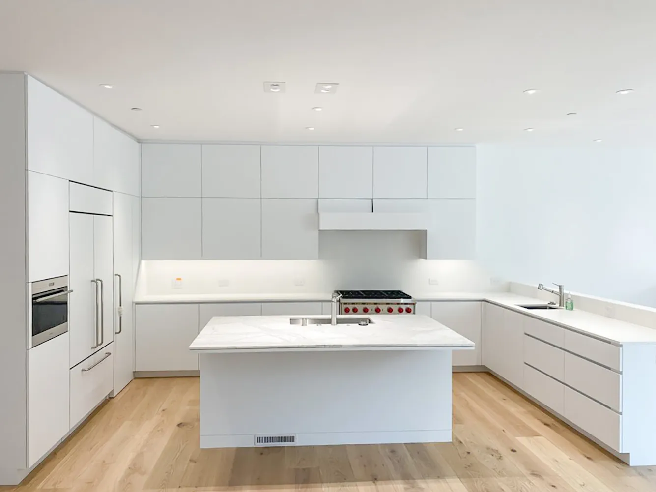 Picture of A pristine, minimalist kitchen showcases Electro-Integrity's commitment to quality outcomes. The clean lines and bright lighting enhance the space, epitomizing the company's top-rated Quality. Copyright ©2025 Diamond Certified Resource

 - Electro-Integrity