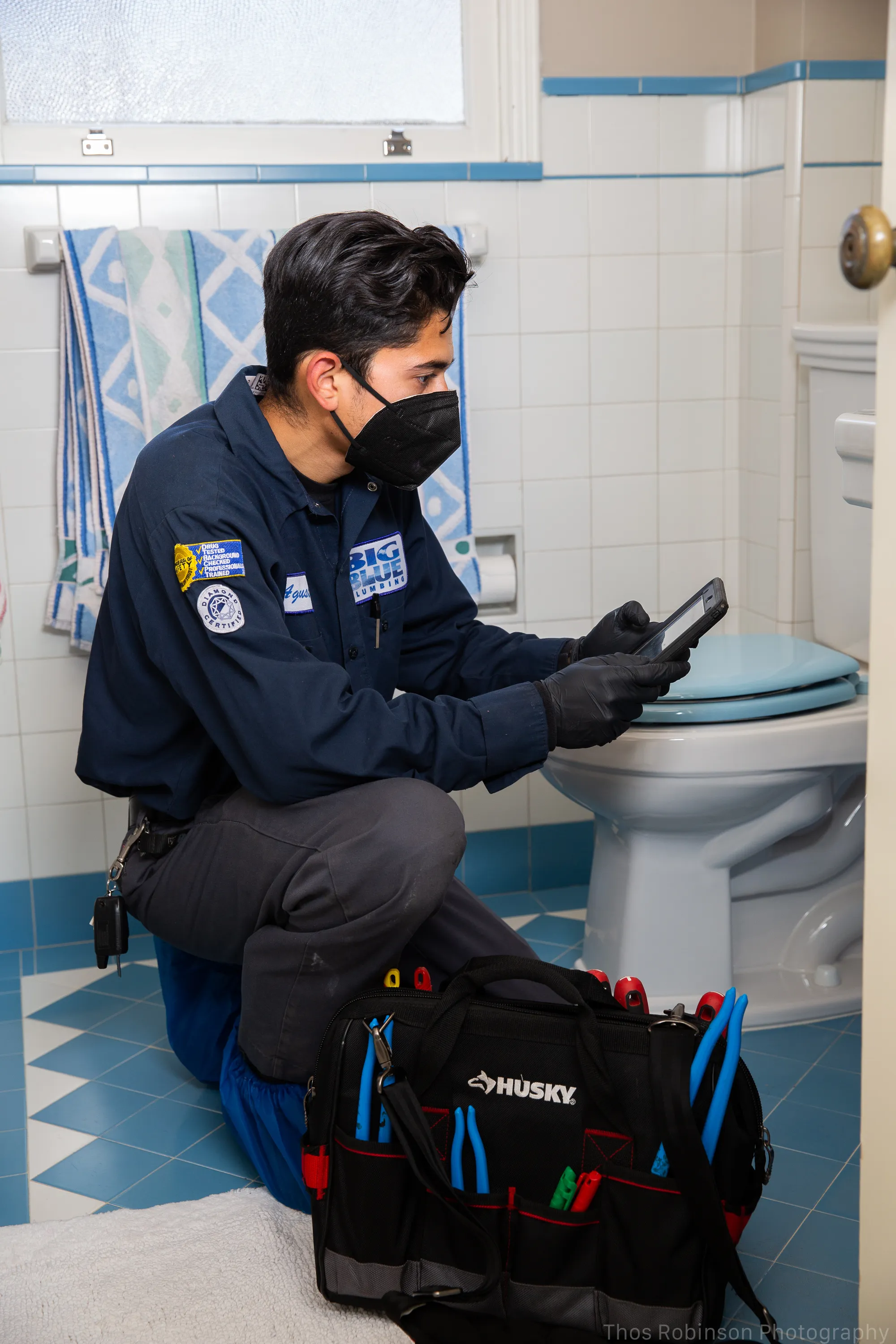 Picture of A Big Blue Plumbing technician focuses intently on diagnostics, reflecting the company's commitment to quality outcomes. Their expertise consistently earns them a Highest in Quality rating. Copyright ©2025 Diamond Certified Resource - Big Blue Plumbing