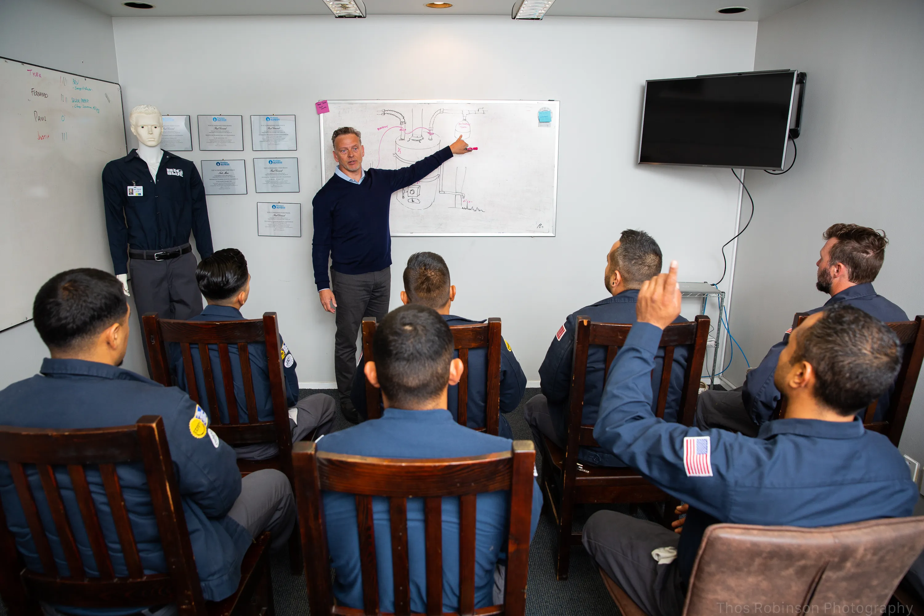 Picture of In a focused training session, Big Blue Plumbing staff engage with detailed schematics, underscoring their commitment to quality outcomes. The company's dedication to excellence is continually proven by its consistent Highest in Quality rating. Copyright ©2025 Diamond Certified Resource

 - Big Blue Plumbing