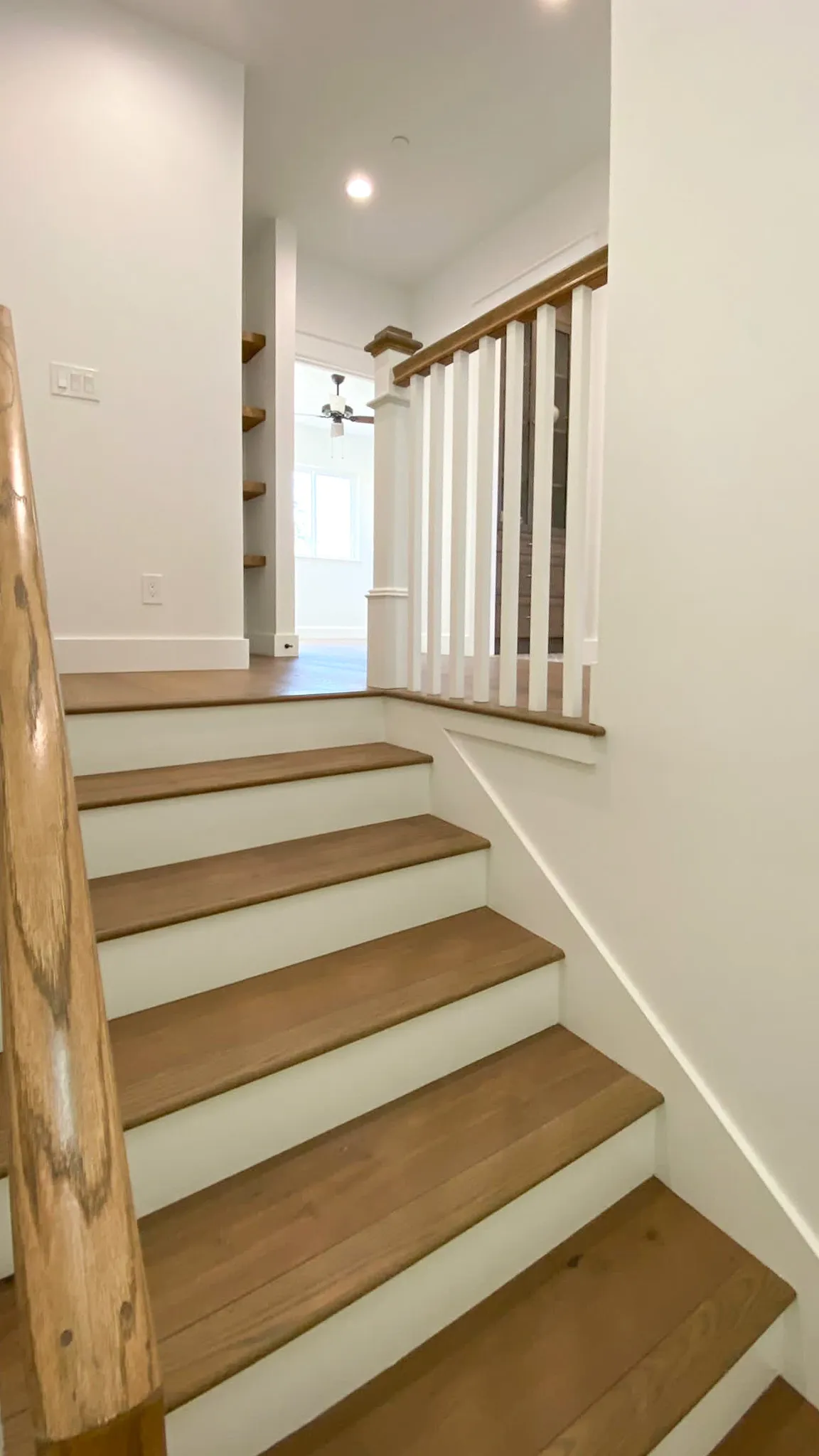 Picture of A newly finished staircase showcases Mana Construction Inc.'s commitment to quality outcomes, featuring smooth wooden steps leading to a sunlit room, a testament to their high customer satisfaction. Copyright ©2025 Diamond Certified Resource

 - Mana Construction Inc.