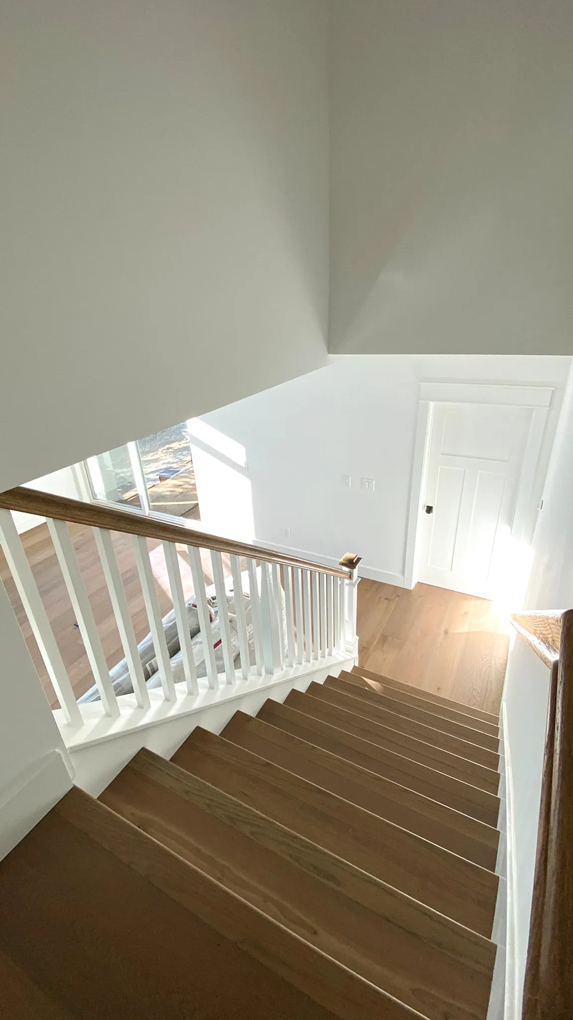 Picture of Sunlight streams through a window, highlighting the craftsmanship of newly installed wooden stairs by Mana Construction Inc. The precision in each detail reflects the companyâ€™s commitment to quality outcomes, consistently earning them a Highest in Quality rating. Copyright ©2025 Diamond Certified Resource

 - Mana Construction Inc.