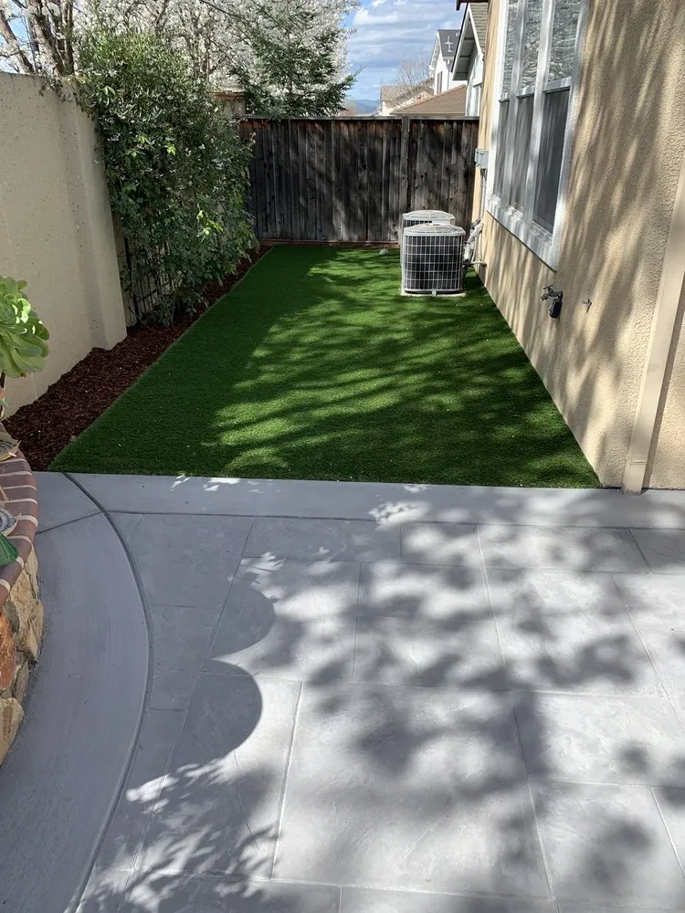 Picture of A serene backyard transformation by ARP Hardscape showcases artificial turf bordered by a new fence. This project reflects the company's focus on quality outcomes, creating inviting outdoor spaces. Copyright ©2025 Diamond Certified Resource

 - ARP Hardscape