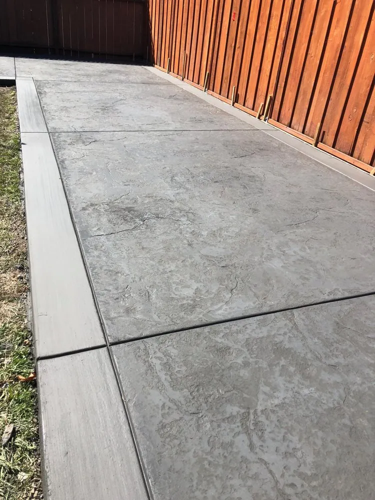 Picture of The sleek, stamped concrete walkway reflects ARP Hardscape's dedication to quality outcomes. This detailed craftsmanship hints at their expertise in transforming ordinary spaces into functional art. ARP Hardscape consistently achieves a Highest in Quality rating. Copyright ©2025 Diamond Certified Resource

 - ARP Hardscape