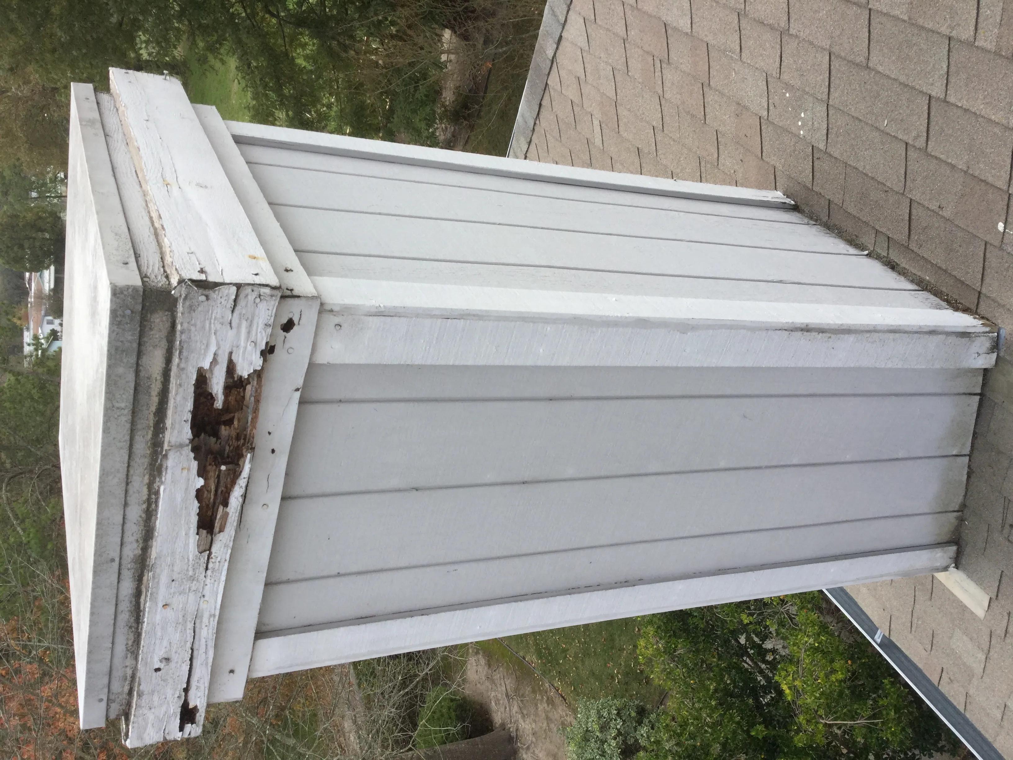 Picture of A weathered chimney reveals exposed wood and deterioration, highlighting the need for expert intervention. Solidarity Painting, Inc. addresses such challenges with a focus on quality outcomes. Copyright ©2025 Diamond Certified Resource - Solidarity Painting, Inc.